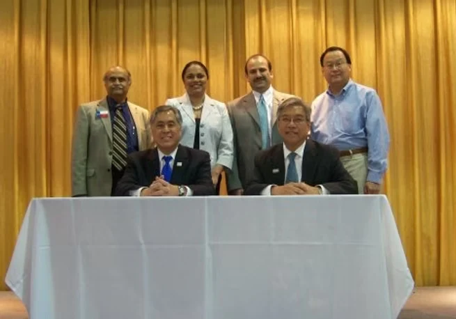 Group portrait with two people seated and four standing behind them.
